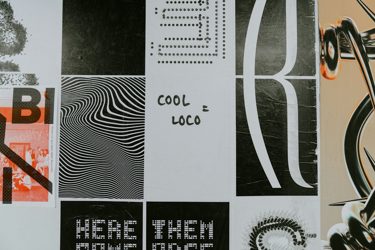 Collage of graphic design posters and art on a wall.