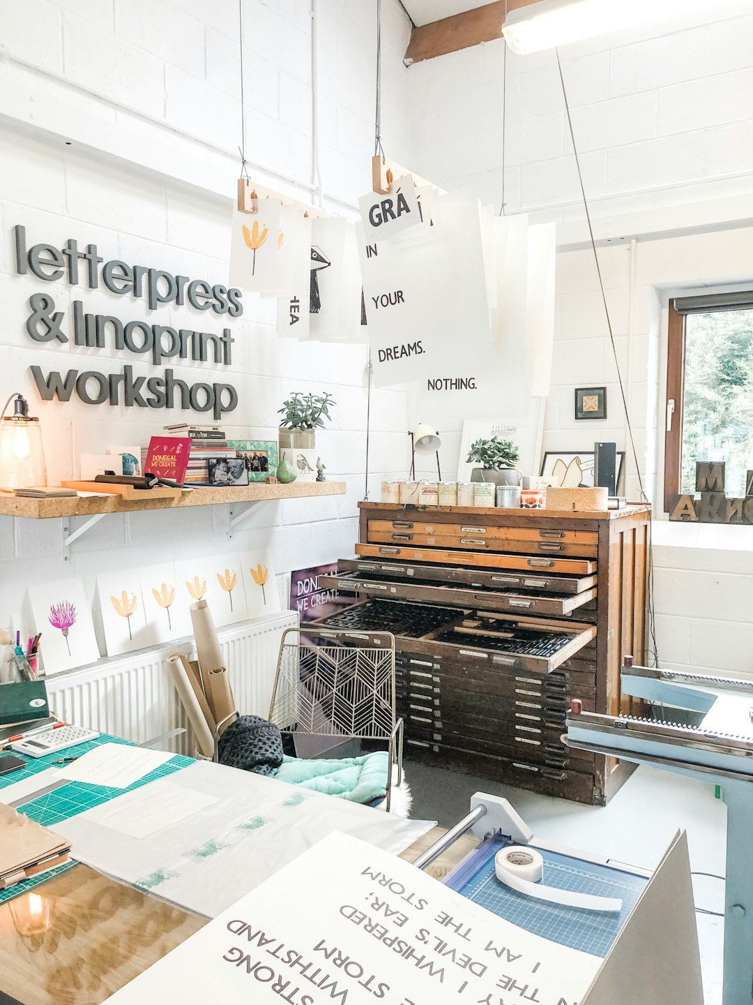 Letterpress and linoprint workshop with vintage type cabinet and tools.