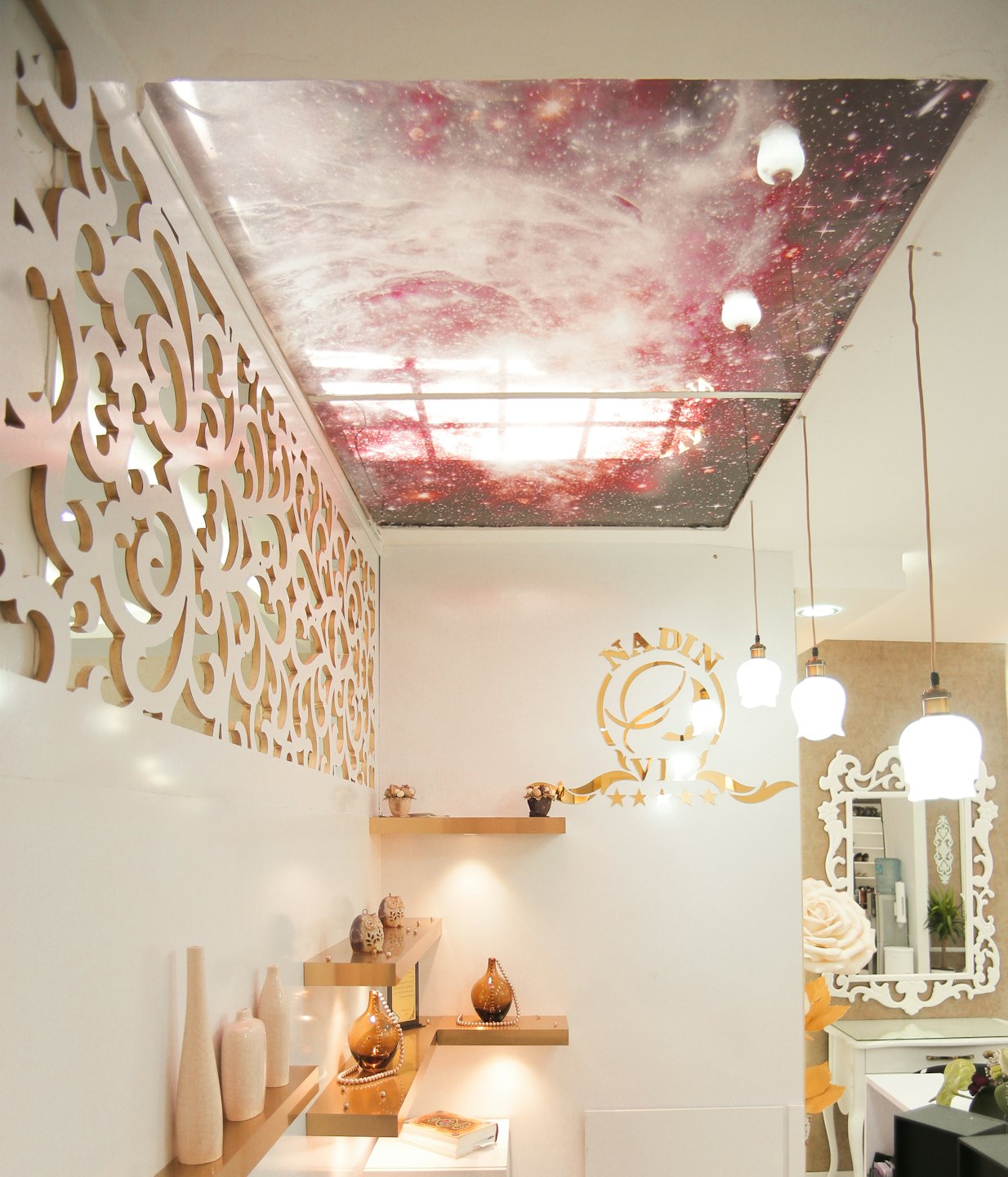 Modern boutique interior featuring a galaxy ceiling and golden shelves.